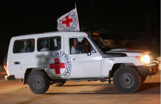 Red Cross vehicle driving Israeli hostages to the Israeli border, when being released. credit: Shay Saig’s FB page.